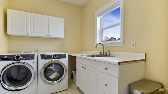 clothes washing area featuring light tile patterned floors, washing machine and clothes dryer, a sink, and cabinet space