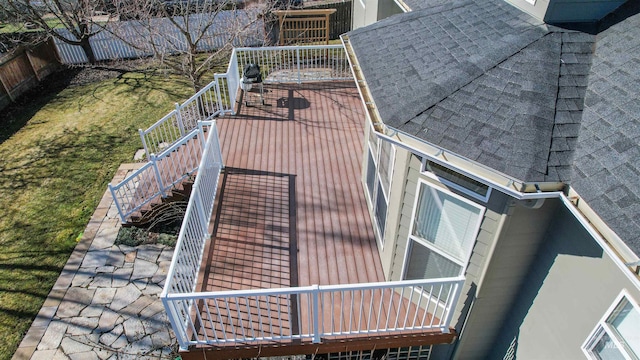 exterior space featuring stairs, fence, and roof with shingles