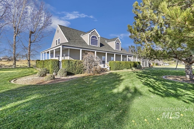 view of front facade with a front yard and covered porch