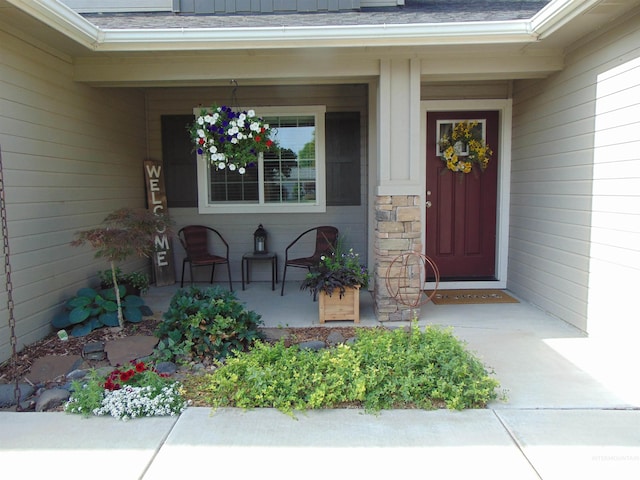983 S St, Vale, OR 97918 - view of exterior entry featuring covered porch, stone siding, and roof with shingles