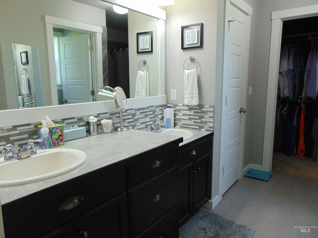 983 S St, Vale, OR 97918 - full bathroom featuring double vanity, tasteful backsplash, and a spacious closet