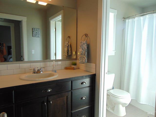 983 S St, Vale, OR 97918 - bathroom with backsplash, vanity, and a shower with shower curtain