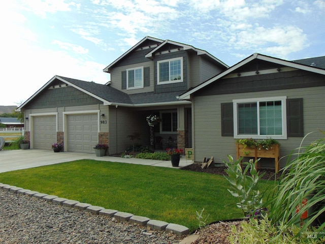 983 S St, Vale, OR 97918 - craftsman inspired home featuring concrete driveway, a front yard, a garage, and stone siding