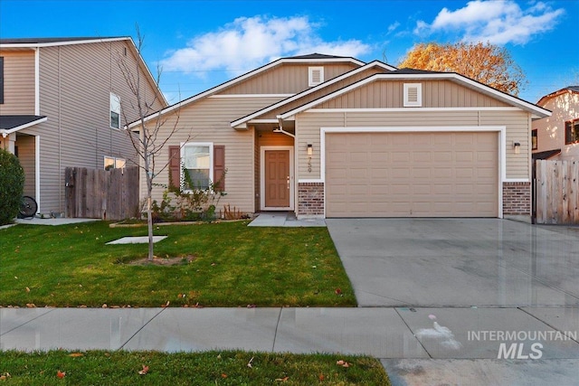 view of front of house with a front yard and a garage