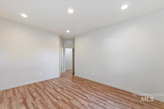 unfurnished room with light wood-type flooring