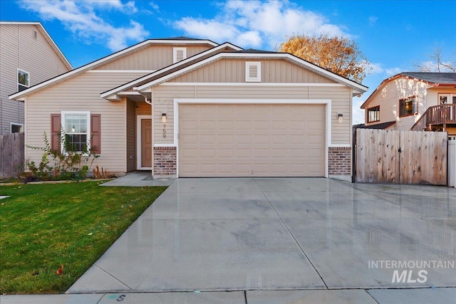 view of front of house with a front yard and a garage