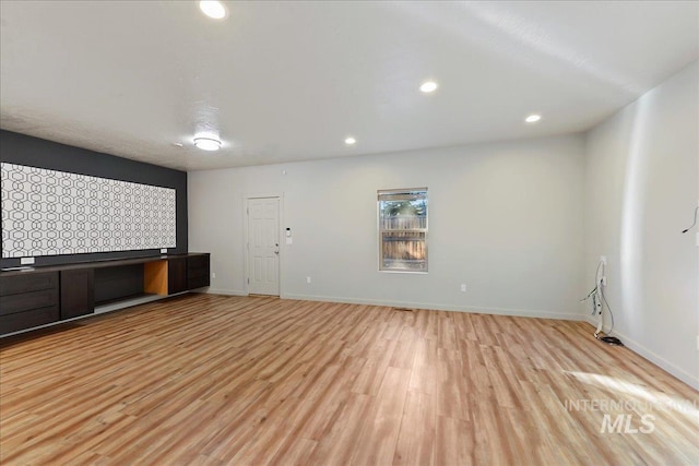 unfurnished living room with light hardwood / wood-style flooring