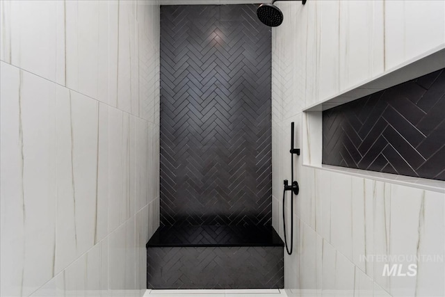 bathroom with a tile shower