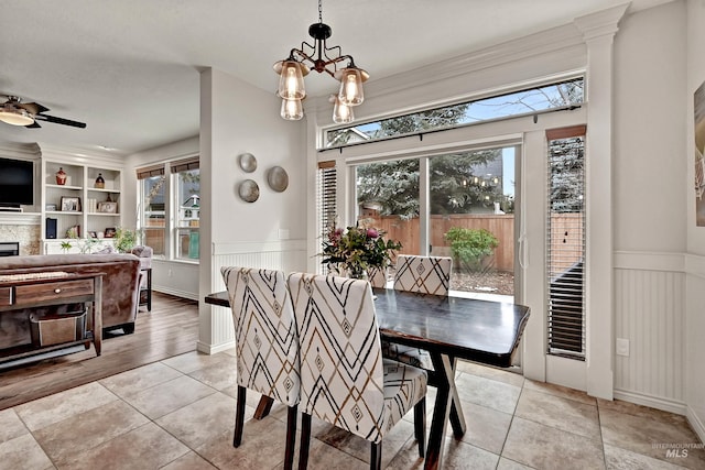 dining space featuring ceiling fan with notable chandelier and light tile patterned floors