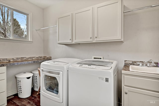 washroom with cabinets, separate washer and dryer, sink, and dark hardwood / wood-style flooring