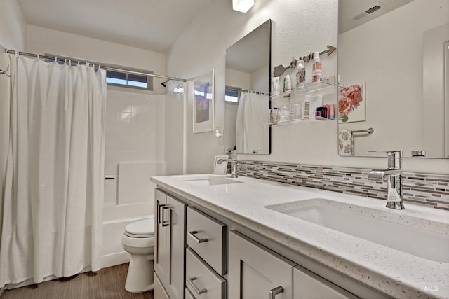 full bathroom with tasteful backsplash, wood-type flooring, toilet, and shower / bath combo with shower curtain