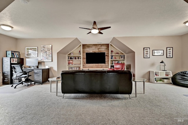 living room featuring ceiling fan, light colored carpet, built in features, and a textured ceiling