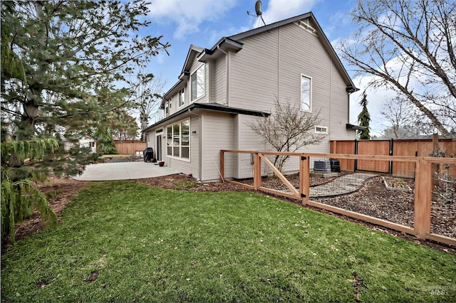 rear view of house featuring central air condition unit, a patio area, and a lawn