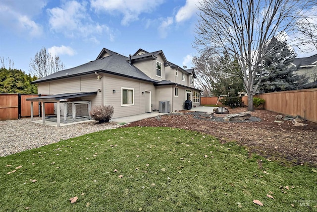 back of house with central AC, a yard, and a patio area