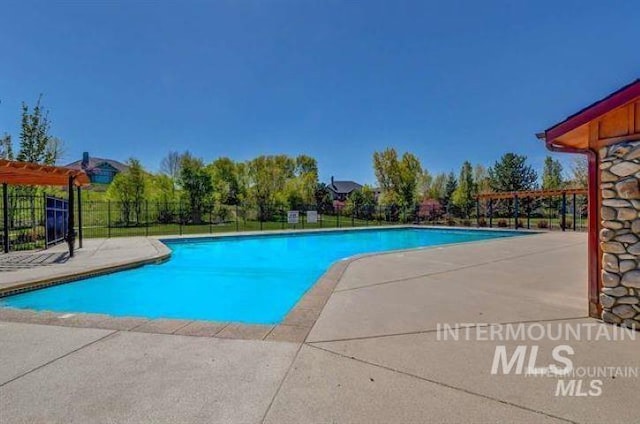 view of swimming pool featuring a pergola and a patio area