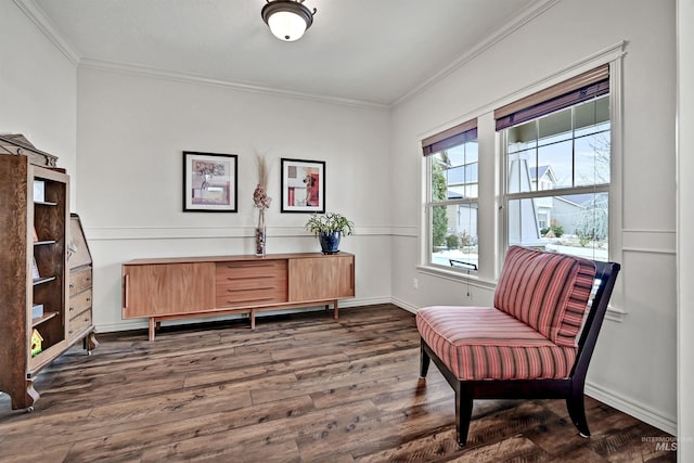 sitting room featuring dark wood-type flooring and ornamental molding