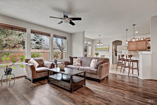 living room with dark hardwood / wood-style floors, sink, a textured ceiling, and ceiling fan