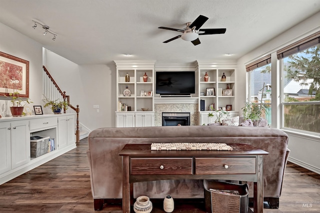 living room featuring ceiling fan and dark hardwood / wood-style flooring