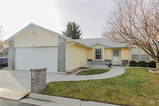 ranch-style home with covered porch, a garage, and a front yard