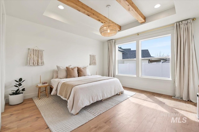 bedroom featuring light wood-style floors, recessed lighting, beamed ceiling, and baseboards