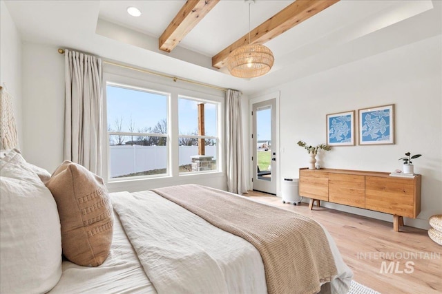 bedroom featuring access to exterior, beamed ceiling, and light wood finished floors