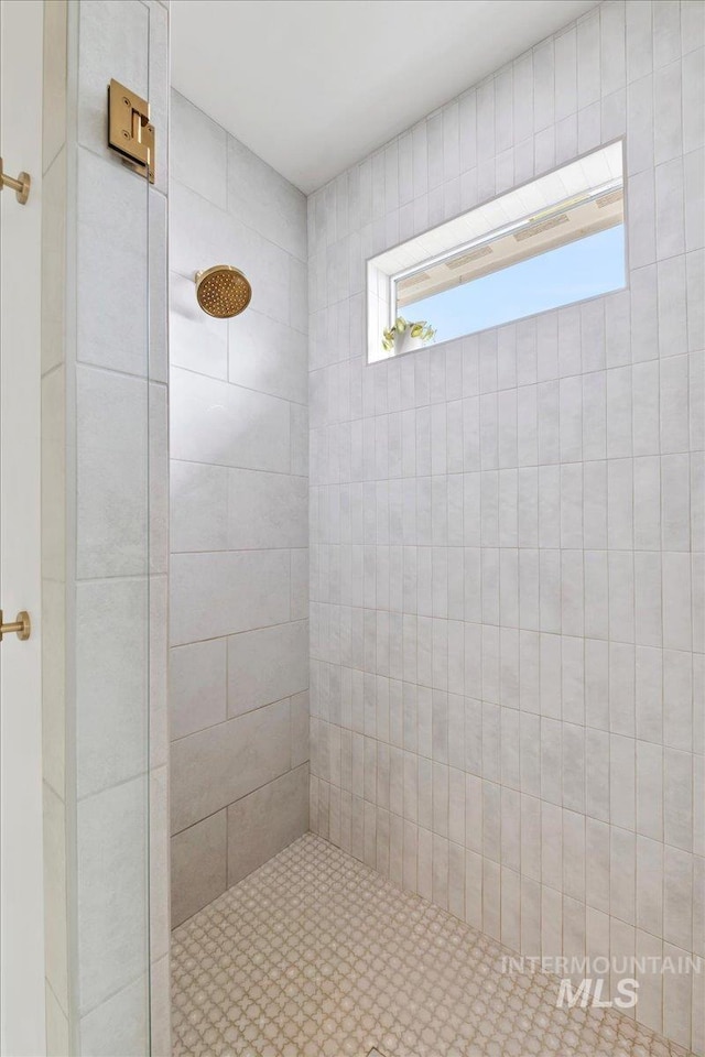 bathroom with a tile shower