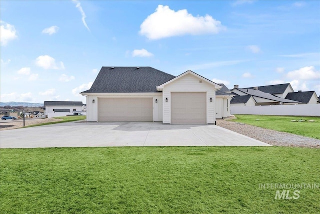 view of front of house with an attached garage, driveway, a front lawn, and fence