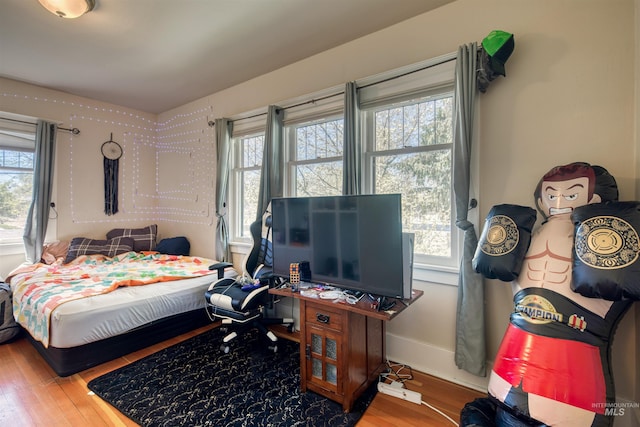 bedroom featuring baseboards and wood finished floors