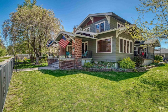 view of front facade featuring a porch, a front yard, and fence