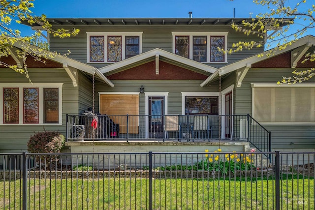 view of front of house with a fenced front yard and a front yard