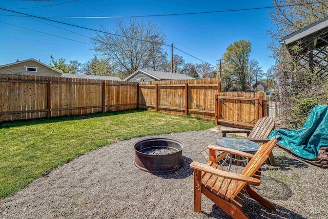 view of yard with a patio, a fire pit, and a fenced backyard