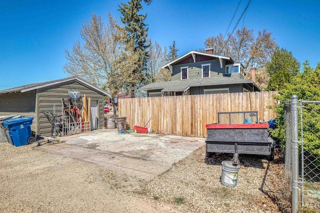 view of yard with a patio area, an outbuilding, and fence