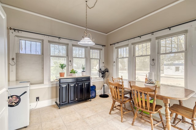 dining room with washer / dryer, light tile patterned flooring, baseboards, and ornamental molding