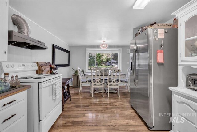 1315 E Lincoln Ave, Nampa, ID 83686 - kitchen featuring white range with electric cooktop, stainless steel refrigerator with ice dispenser, light wood-type flooring, white cabinets, and extractor fan