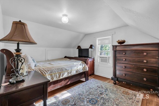 1315 E Lincoln Ave, Nampa, ID 83686 - bedroom featuring vaulted ceiling, wood finished floors, and cooling unit
