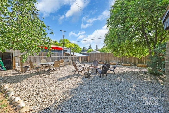 1315 E Lincoln Ave, Nampa, ID 83686 - fenced backyard with an outdoor fire pit and a patio area