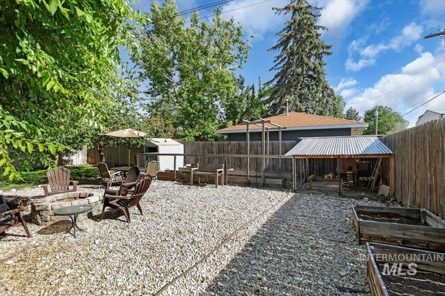 1315 E Lincoln Ave, Nampa, ID 83686 - fenced backyard featuring a fire pit