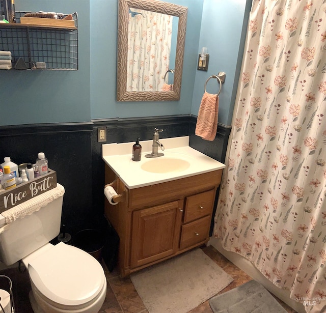 bathroom featuring vanity, walk in shower, tile patterned floors, and toilet