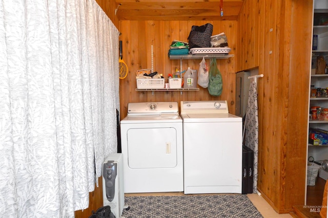 washroom featuring separate washer and dryer and wood walls