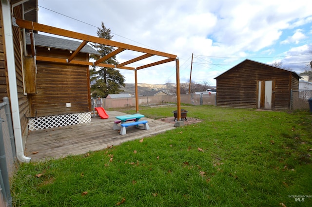 view of yard featuring a storage shed and a deck