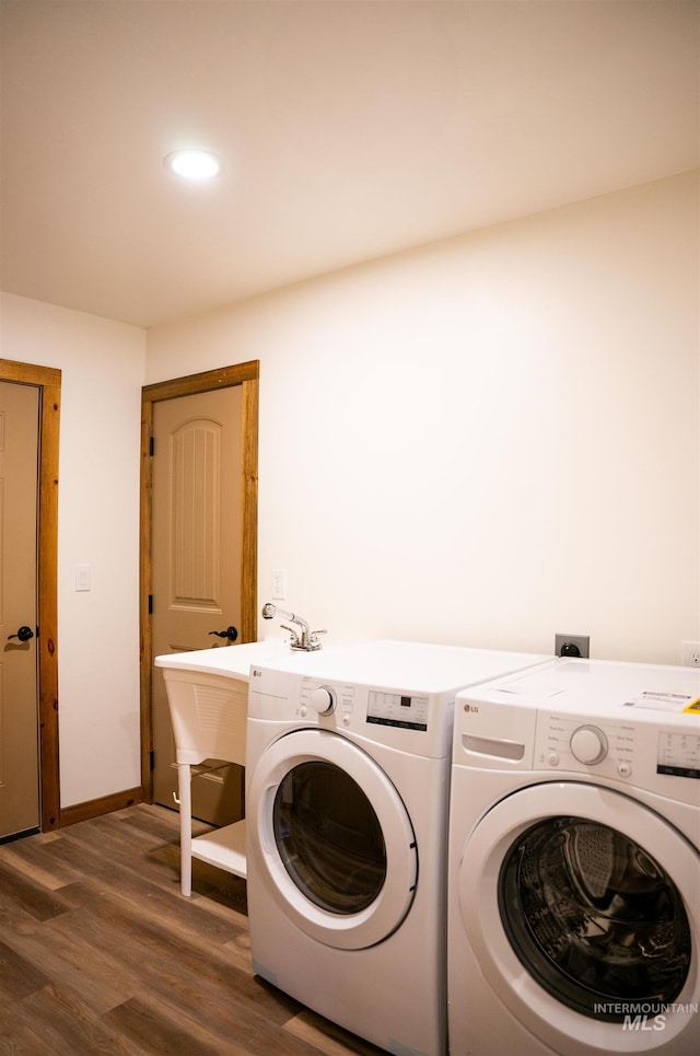 washroom with washing machine and dryer and dark hardwood / wood-style flooring