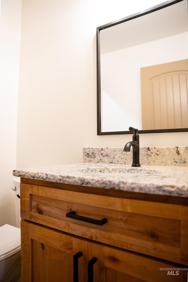 bathroom featuring toilet and vanity