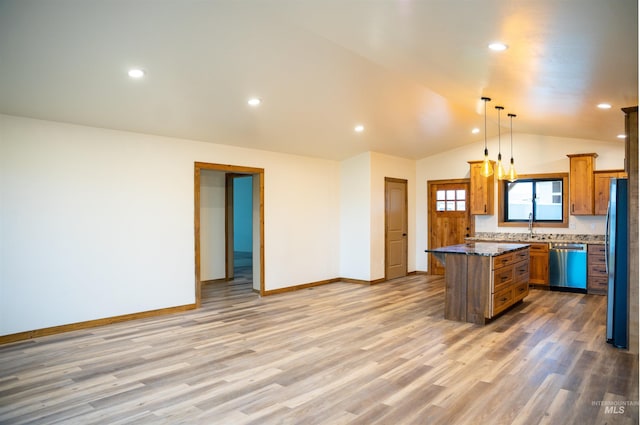 kitchen with a center island, light wood-type flooring, pendant lighting, and appliances with stainless steel finishes