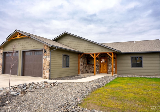 view of front of home with a front lawn and a garage