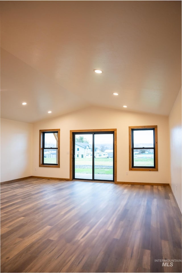 spare room with vaulted ceiling and dark hardwood / wood-style floors