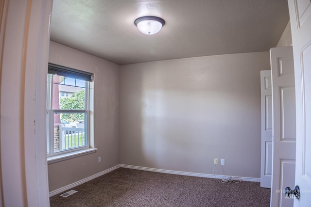 1155 Caswell Ave W, Twin Falls, ID 83301 - spare room with dark colored carpet and baseboards