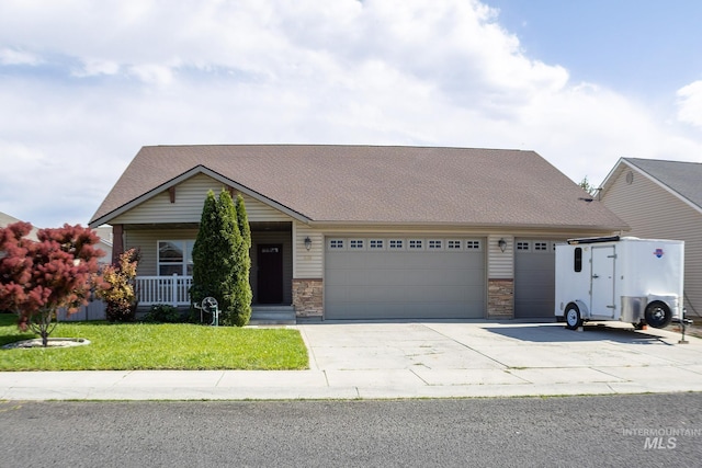 1155 Caswell Ave W, Twin Falls, ID 83301 - view of front of property with a garage, driveway, a front lawn, covered porch, and stone siding