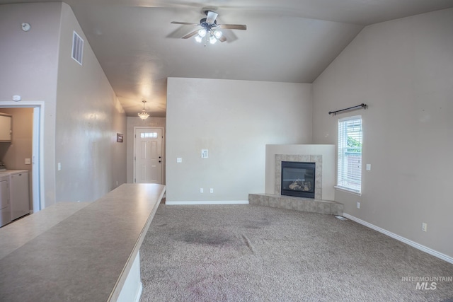 1155 Caswell Ave W, Twin Falls, ID 83301 - unfurnished living room featuring separate washer and dryer, ceiling fan, lofted ceiling, a fireplace, and carpet flooring