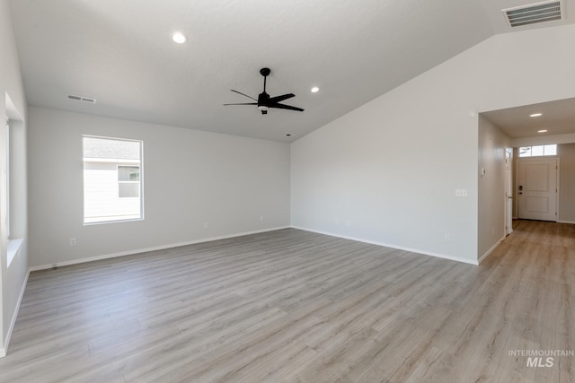 unfurnished room featuring a wealth of natural light, visible vents, ceiling fan, and vaulted ceiling