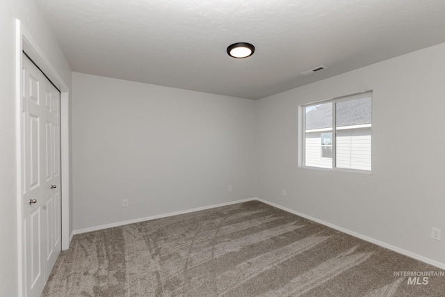 unfurnished bedroom featuring a closet, carpet floors, and baseboards